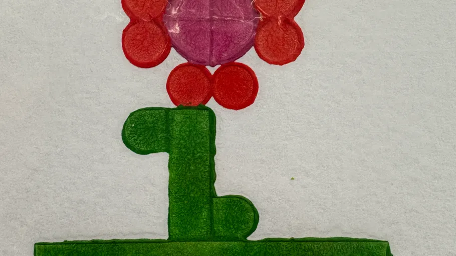 Colorful flower drawing on textured paper.