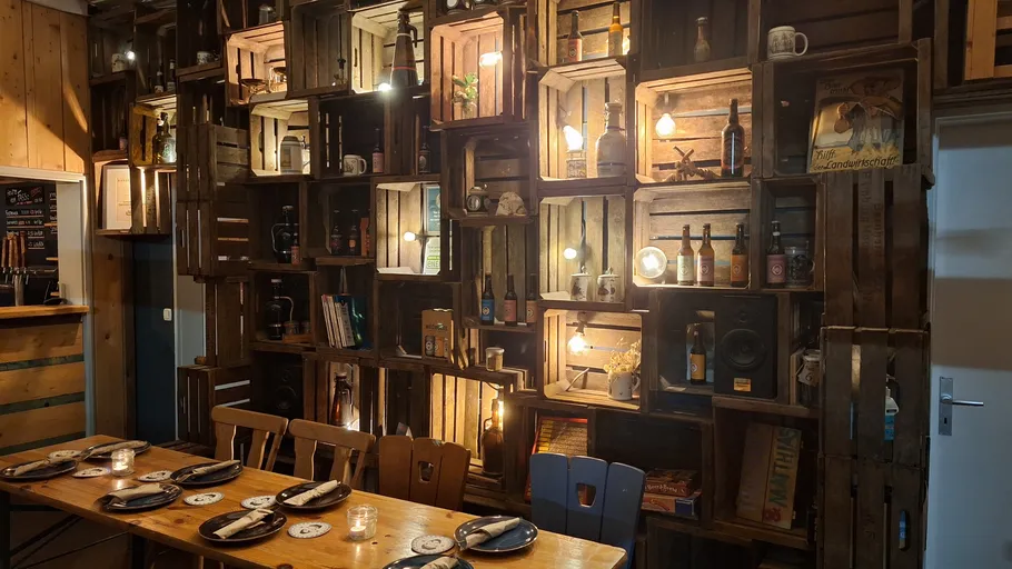Wooden crates with lights and decorations on wall.