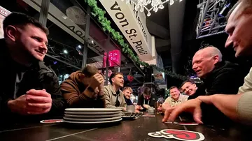 Group of people laughing in a bar.