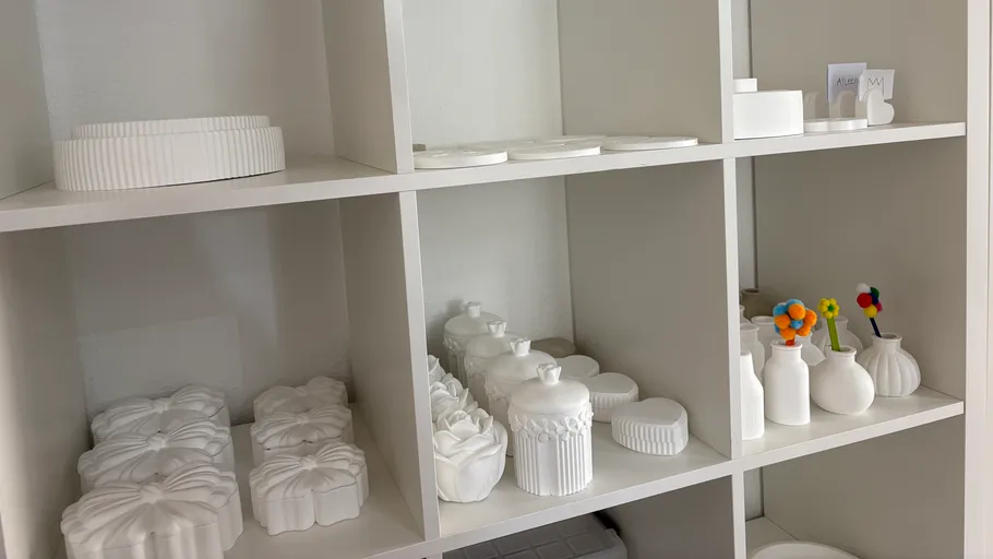 White ceramic objects displayed on shelves.
