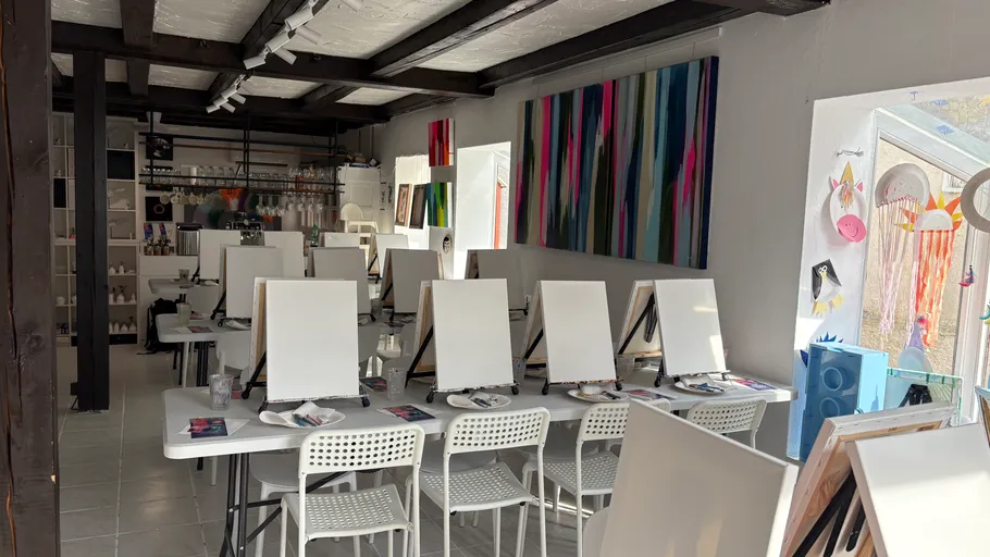 Empty painting class with easels and chairs.