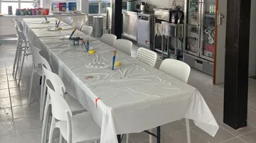 Table set for painting workshop in kitchen space.