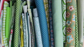Colorful fabric rolls in various patterns.