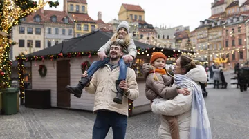 Happy family during winter at festive street.