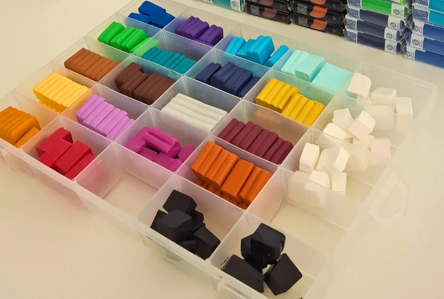 Colorful clay blocks organized in storage box.