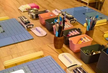 Craft supplies organized on wooden table.