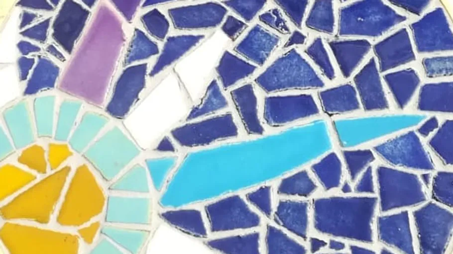 Colorful mosaic with blue, purple, yellow tiles.