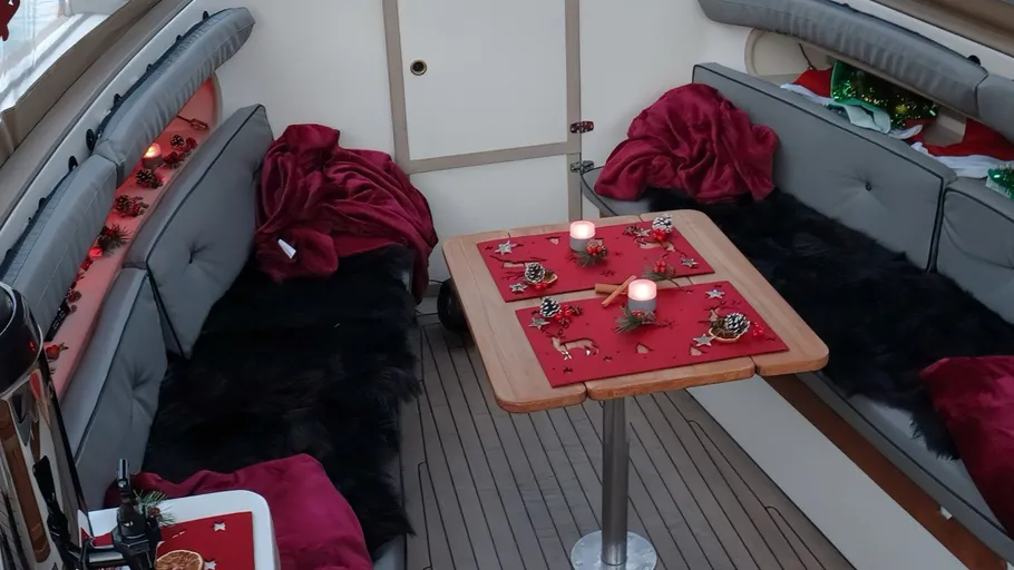 Boat interior with festive Christmas table setting.