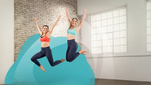 Two women jumping in a studio.