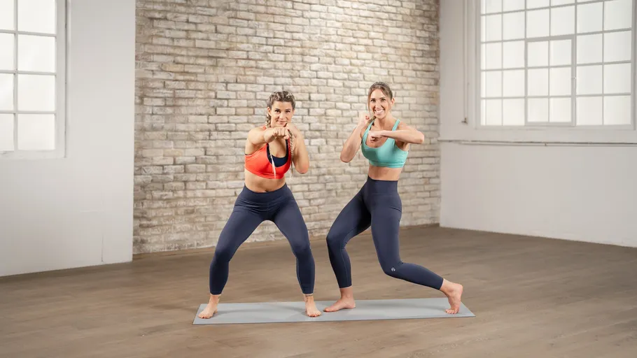 Two women exercising in bright room.