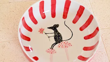 Ceramic bowl with mouse and flower design.