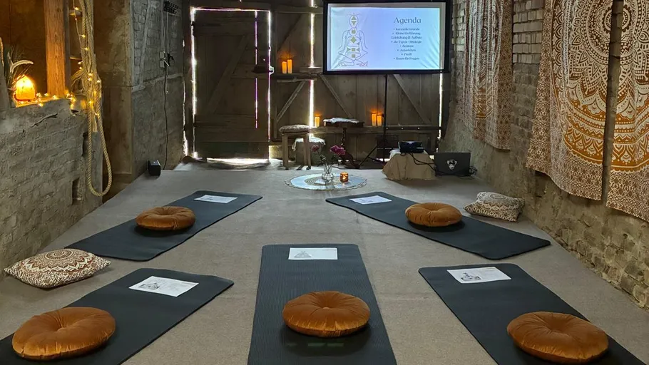Yoga mats and cushions in rustic room.