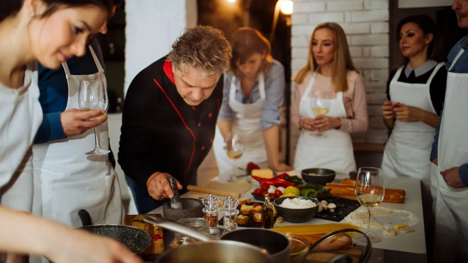 Group cooking class with chef instructing.