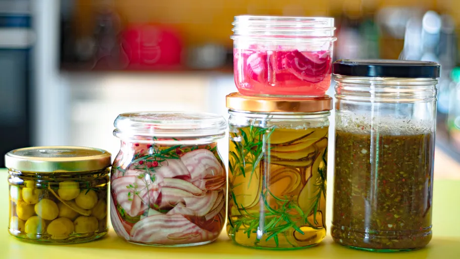 Jars of pickled vegetables on table.