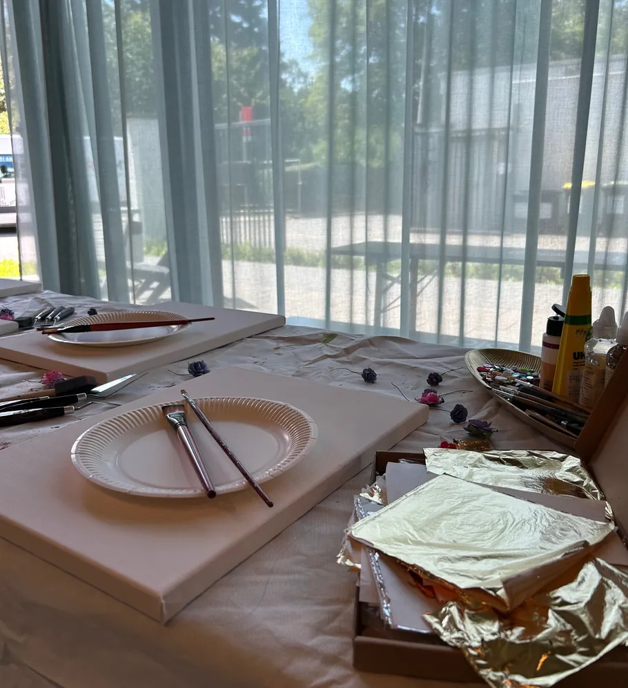 Art supplies on table by window.