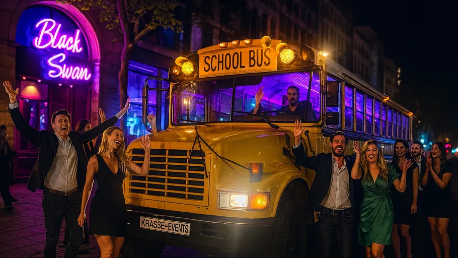 Group celebrating beside lit party bus.
