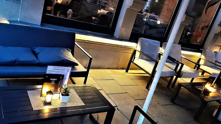 Outdoor seating area with tables and chairs.
