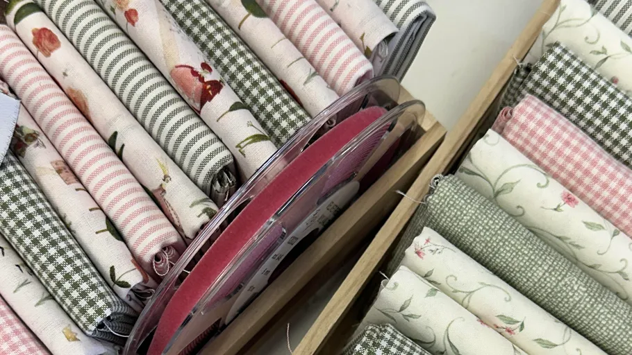 Rolled fabrics with floral and check patterns.