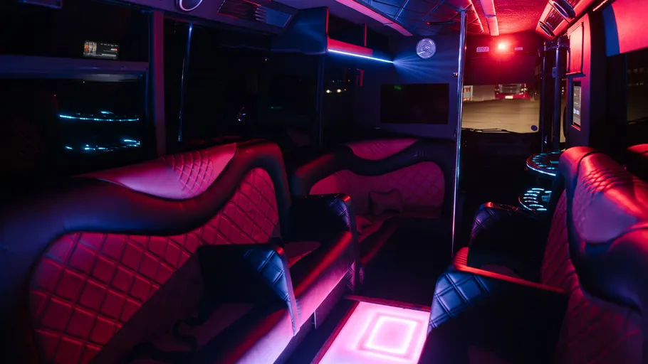 Interior of party bus with neon lights.