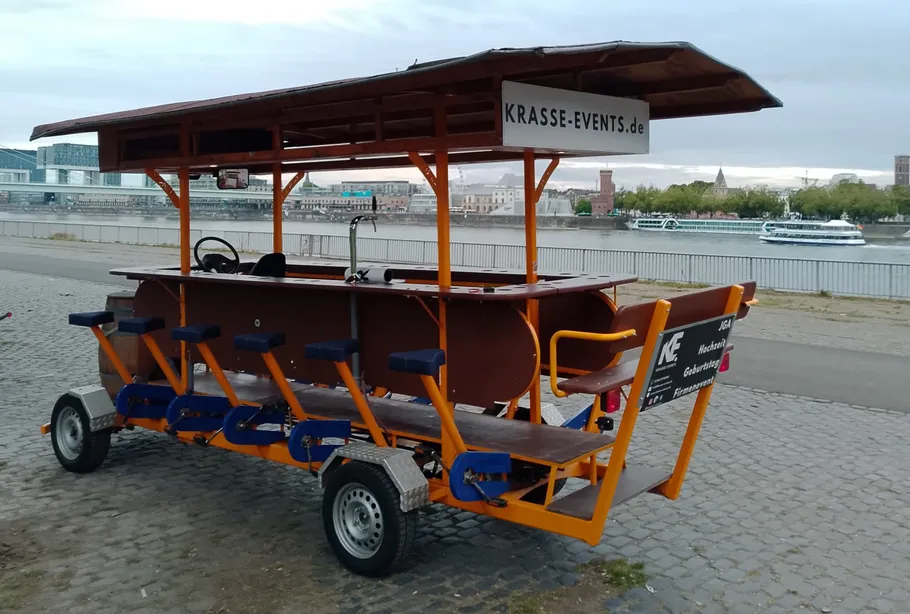 Pedal-powered bar cart near waterfront.