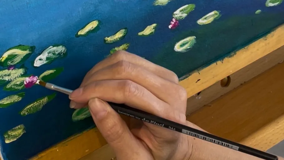 Hand painting small details on canvas.