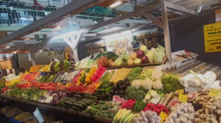 Vegetable stall displaying fresh produce indoors.