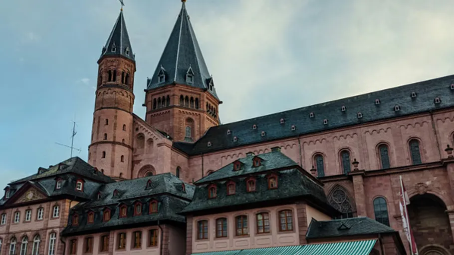 Historic cathedral with towers under cloudy sky.