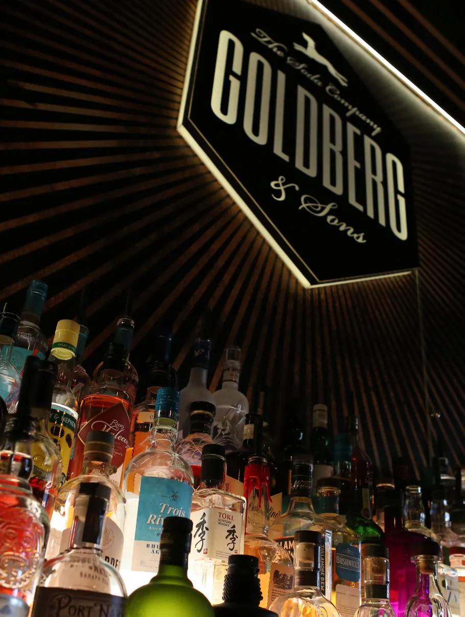 Backlit sign with liquor bottles underneath.