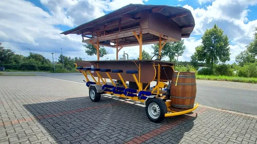Pedal-powered bar on a sunny street.