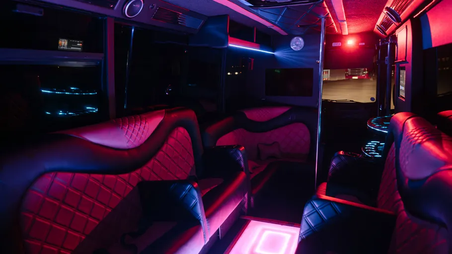 Luxury party bus with neon lighting inside.