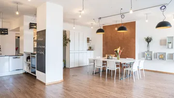 Modern kitchen and dining area with decor.