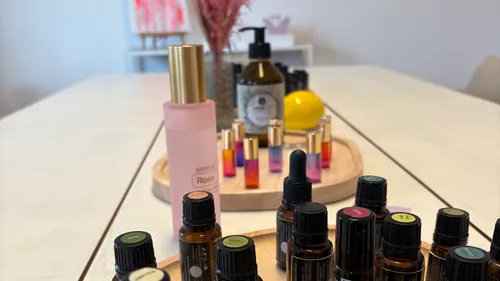 Aromatherapie-Flaschen auf einem Holztisch angeordnet.