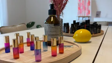 Colorful vials on a wooden tray, indoors.