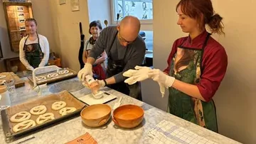 People making pretzels in a kitchen workshop.