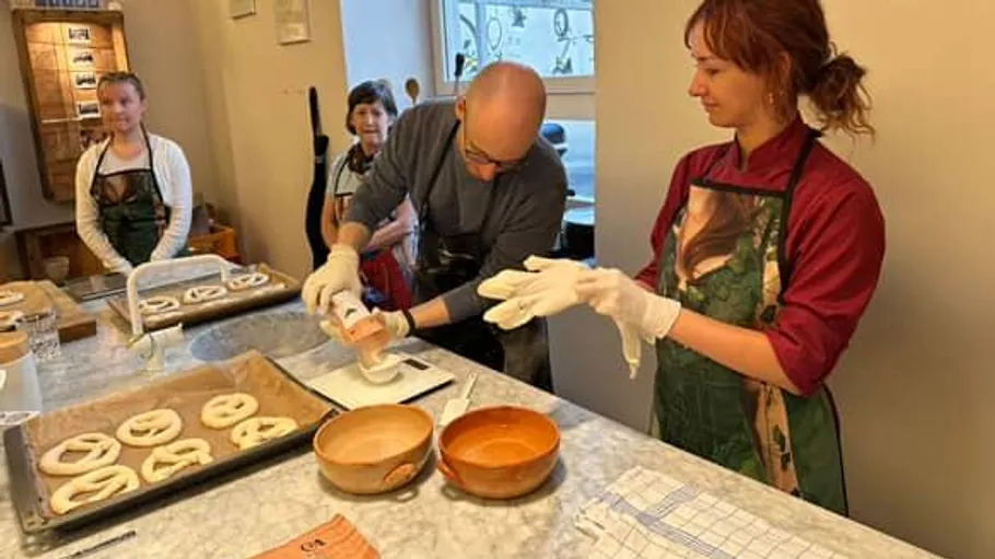 People making pretzels in a kitchen workshop.