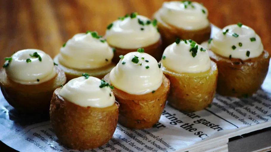 Small potatoes topped with cream and herbs.