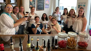 Group of women toasting in a cafe.