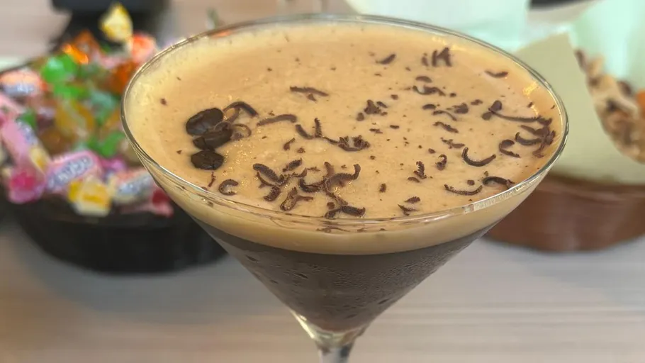 Espresso martini garnished with coffee beans.
