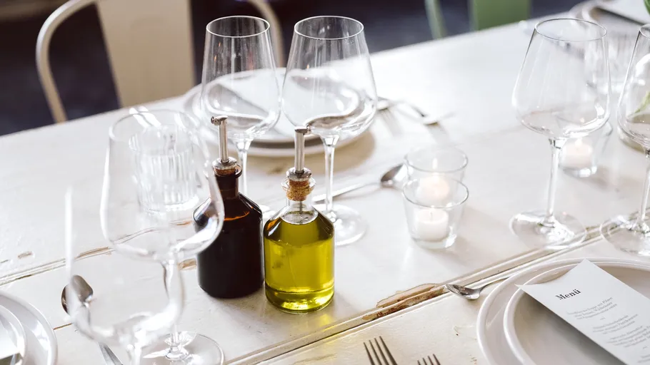 Elegant table setting with wine glasses, candles.