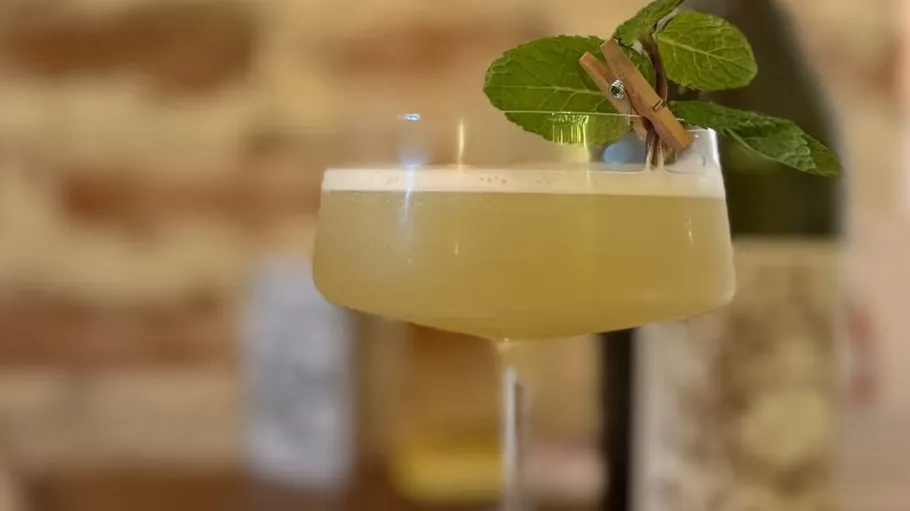 Cocktail with mint on a wooden background.