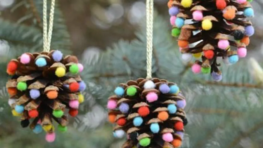 Decorated pinecones hanging from tree branches.