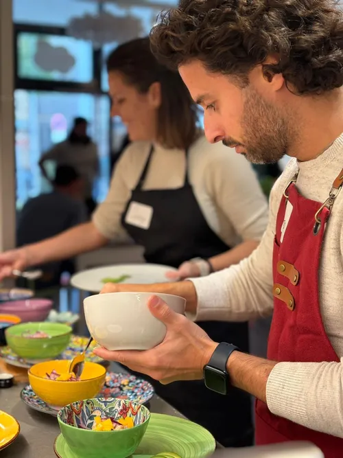 Two people preparing food in a kitchen.