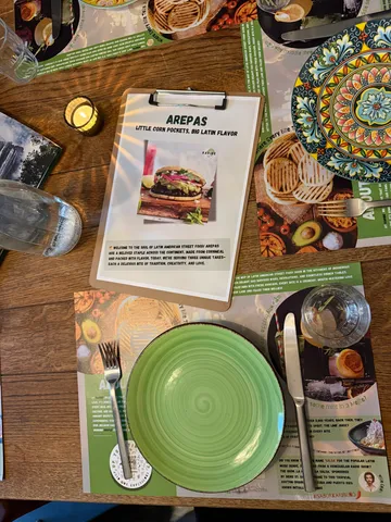 Table setting with menu, plate, and utensils.