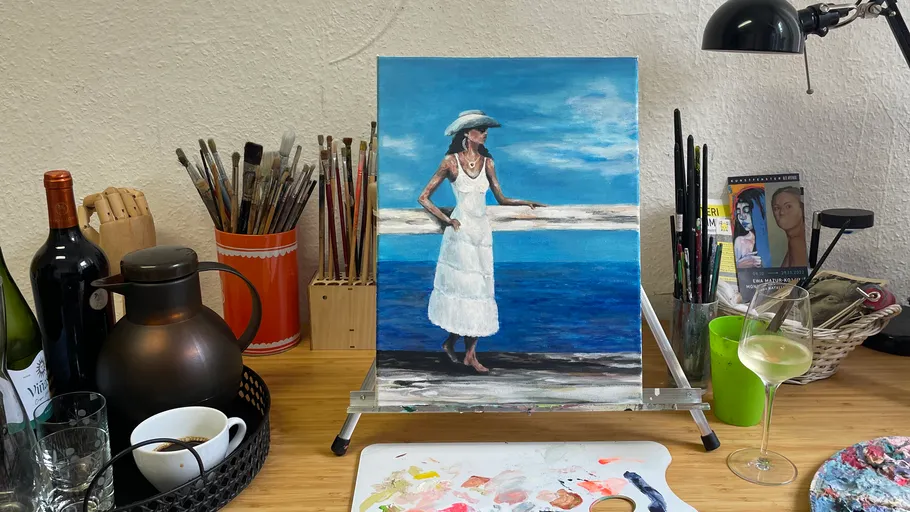 Painting of woman in white dress on desk.