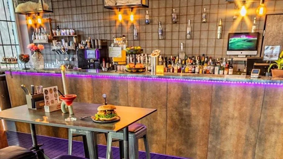 Bar counter with drinks and food displayed.