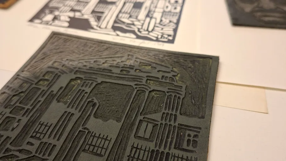 Intricate woodcut block on a table.