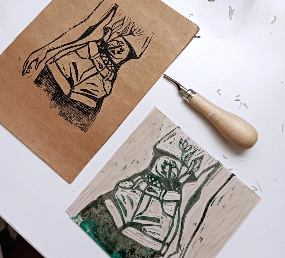 Linocut print, carving tool, and design setup.