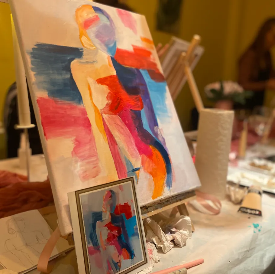 Colorful abstract painting on an easel in studio.