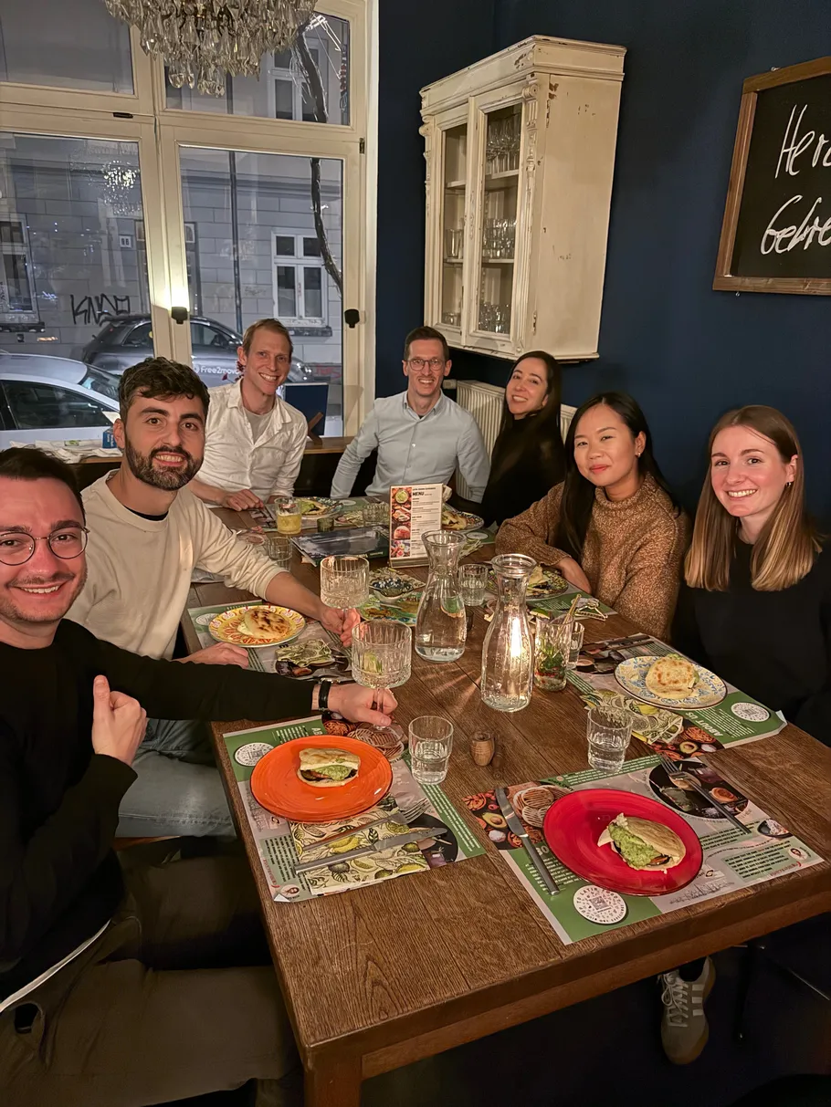 Group of people dining at a table indoors.