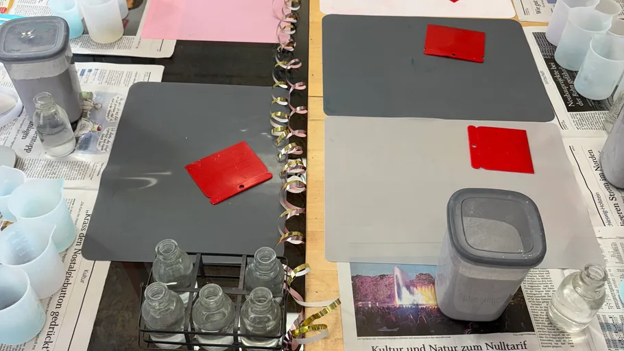 Craft supplies and mats on a table.